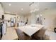 Bright dining area with marble top table and view of kitchen and living areas at 18027 Turning Leaf Cir, Land O Lakes, FL 34638