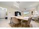 Elegant dining room with a marble table, chandelier, and view to living room at 18027 Turning Leaf Cir, Land O Lakes, FL 34638