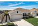 Two-car garage with landscaped front yard at 18027 Turning Leaf Cir, Land O Lakes, FL 34638