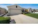Two-car garage and well-manicured lawn at 18027 Turning Leaf Cir, Land O Lakes, FL 34638