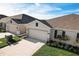 Two-story home with attached garage and landscaping at 18027 Turning Leaf Cir, Land O Lakes, FL 34638