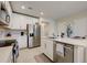 Modern kitchen with white cabinets, stainless steel appliances and an island at 18027 Turning Leaf Cir, Land O Lakes, FL 34638