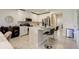 Modern kitchen with white cabinets, stainless steel appliances, and an island at 18027 Turning Leaf Cir, Land O Lakes, FL 34638