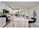Modern kitchen with white cabinets, stainless steel appliances and an island at 18027 Turning Leaf Cir, Land O Lakes, FL 34638