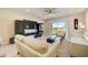 Spacious living room with patio access, comfortable seating, and a large TV at 18027 Turning Leaf Cir, Land O Lakes, FL 34638