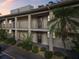 Two-story condo building with balconies and lush landscaping at 19029 Us Highway 19 N # 1-3, Clearwater, FL 33764