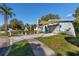 Light blue house with a two-car garage and landscaped yard at 306 Inlet Ct, Largo, FL 33756