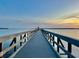 Long pier extending into calm waters at sunset at 329 Country Club Dr, Oldsmar, FL 34677