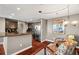 Inviting dining area near the kitchen, featuring hardwood floors and a modern chandelier at 345 Bayshore Blvd # 308, Tampa, FL 33606