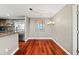 Open dining space with hardwood floors adjacent to the kitchen, illuminated by modern lighting at 345 Bayshore Blvd # 308, Tampa, FL 33606