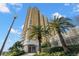 Beautiful high-rise condo building with manicured landscaping and palm trees against a blue sky at 345 Bayshore Blvd # 308, Tampa, FL 33606