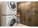 This laundry room features a stacked washer and dryer, plus a wall of tall cabinets at 345 Bayshore Blvd # 308, Tampa, FL 33606
