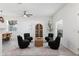 Living room featuring four black armchairs, a coffee table, and hardwood floors at 6003 Candytuft Pl, Land O Lakes, FL 34639