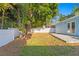 Spacious backyard with a partial view of a concrete patio and a white privacy fence at 615 W Virginia Ave, Tampa, FL 33603