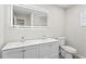 Bright bathroom with a double sink vanity, illuminated mirror, and a separate shower area at 615 W Virginia Ave, Tampa, FL 33603