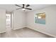 Bright bedroom featuring wood-look floors, a ceiling fan, and a window with natural light at 615 W Virginia Ave, Tampa, FL 33603