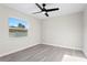 A sunlit bedroom featuring a modern ceiling fan and luxury vinyl plank flooring at 615 W Virginia Ave, Tampa, FL 33603