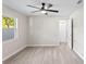 Cozy bedroom featuring wood-look floors, a ceiling fan, and a window at 615 W Virginia Ave, Tampa, FL 33603