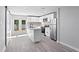 Spacious kitchen with an island, stainless steel appliances, white cabinets, and French doors to the backyard at 615 W Virginia Ave, Tampa, FL 33603