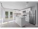 Modern kitchen features white cabinets, stainless steel appliances, and an island with a sink at 615 W Virginia Ave, Tampa, FL 33603
