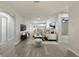 Open-concept living room with hardwood floors that connect to the kitchen and dining areas at 615 W Virginia Ave, Tampa, FL 33603