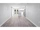 Bright living room with hardwood floors and an open-concept kitchen featuring modern appliances and lots of light at 615 W Virginia Ave, Tampa, FL 33603