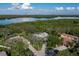 Aerial shot of a home's lot and neighborhood, with a scenic view of the nearby bay and tree coverage at 7255 18Th Ne St, St Petersburg, FL 33702