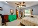 Bedroom with a ceiling fan, dresser, and closet; room is painted in a pastel blue hue at 7255 18Th Ne St, St Petersburg, FL 33702