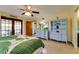 Spacious bedroom with a ceiling fan, French doors to the lanai, and a charming blue hutch at 7255 18Th Ne St, St Petersburg, FL 33702