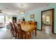 Dining area with a wooden table and chairs, adjacent to the living room and bedroom at 7255 18Th Ne St, St Petersburg, FL 33702