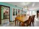 Dining room with a wooden table, chairs, built-in cabinet, decorative light fixture, and access to the living room at 7255 18Th Ne St, St Petersburg, FL 33702