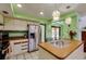 Bright kitchen featuring stainless steel appliances, stylish countertops, and modern pendant lighting at 7255 18Th Ne St, St Petersburg, FL 33702