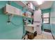 Clean laundry room with a utility sink, stacked washer/dryer, and storage shelves at 7255 18Th Ne St, St Petersburg, FL 33702