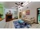 Cozy living room featuring a brick fireplace, built-in shelves, and bright, vibrant decor at 7255 18Th Ne St, St Petersburg, FL 33702