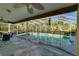 Backyard screened-in pool with gray stone patio and a seating area at 7255 18Th Ne St, St Petersburg, FL 33702