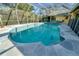 Backyard screened-in pool with a gray stone patio and a yard at 7255 18Th Ne St, St Petersburg, FL 33702
