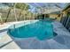 Sparkling screened-in pool with surrounding stone patio for outdoor enjoyment at 7255 18Th Ne St, St Petersburg, FL 33702