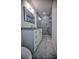 Updated bathroom featuring a walk-in shower and granite countertop at 1042 Idlewild N Dr, Dunedin, FL 34698