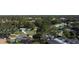 Aerial view of a residential neighborhood showcasing houses nestled among lush trees at 1042 Idlewild N Dr, Dunedin, FL 34698