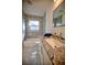 Modern bathroom with granite countertop, updated vanity, and tile shower/tub at 1042 Idlewild N Dr, Dunedin, FL 34698