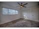 Spacious bedroom featuring a ceiling fan and large window with blinds at 1042 Idlewild N Dr, Dunedin, FL 34698