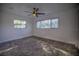Well-lit bedroom with ceiling fan and carpeting at 1042 Idlewild N Dr, Dunedin, FL 34698