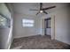 Bright bedroom with ceiling fan, window blinds, and ample closet space at 1042 Idlewild N Dr, Dunedin, FL 34698