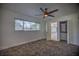 Bright bedroom with ceiling fan, window, and carpeting at 1042 Idlewild N Dr, Dunedin, FL 34698