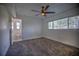 Spacious bedroom with ceiling fan, large window and carpeting at 1042 Idlewild N Dr, Dunedin, FL 34698