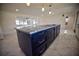 Kitchen island with granite countertop and dark-colored cabinetry at 1042 Idlewild N Dr, Dunedin, FL 34698