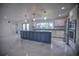 Modern kitchen with white cabinets, large island, and stainless steel appliances at 1042 Idlewild N Dr, Dunedin, FL 34698