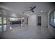 Open concept living room and kitchen with marble-look tile floors at 1042 Idlewild N Dr, Dunedin, FL 34698