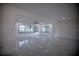 Spacious living area showcasing an open floor plan and large windows at 1042 Idlewild N Dr, Dunedin, FL 34698
