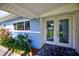 Front entry with double glass doors and stone flooring at 1042 Idlewild N Dr, Dunedin, FL 34698